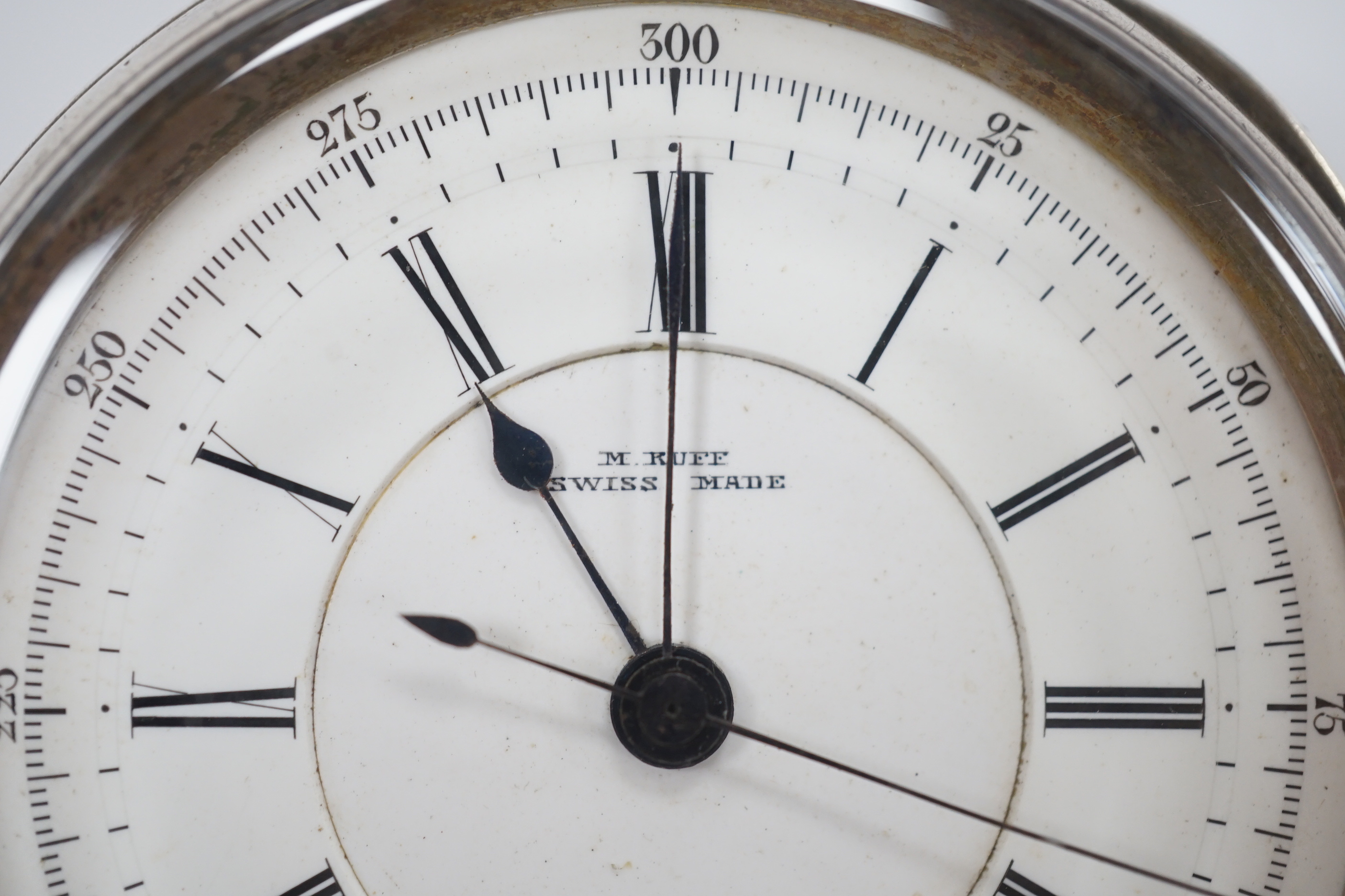 A Swiss white metal cased open faced chronograph pocket watch, by M. Ruff, Porth, with Roman dial.